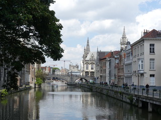 View of the city's water canal. Tourists walk around the city. Tourist boat during the tour.