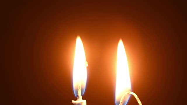 Two burning candles that is consumed over time. One of the candles is turned on at the time of filmingBirthday time. 4K time-lapse