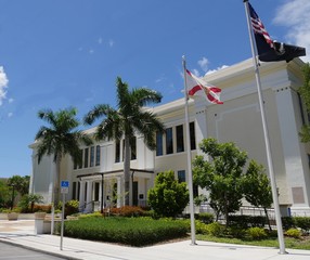 City hall of Key West, Florida, with flags in front.