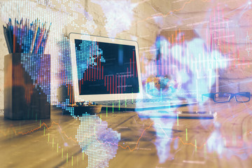 Double exposure of graph and financial info and work space with computer background. Concept of international online trading.