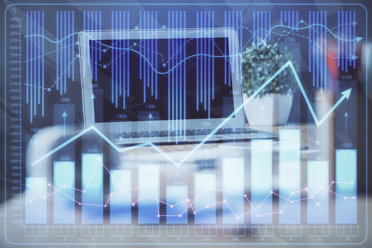 Financial graph colorful drawing and table with computer on background. Multi exposure. Concept of international markets.