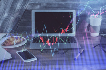 Financial graph colorful drawing and table with computer on background. Multi exposure. Concept of international markets.