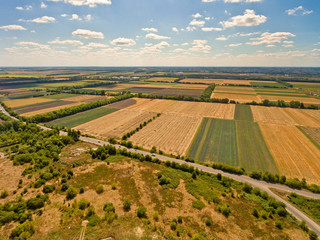 Fototapeta na wymiar Beautiful aerial view of agricultural fields and blue sky with white clouds.