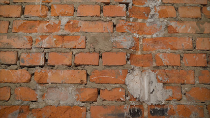 Weathered stained old orange and red brick wall, texture grunge background. Brick wall before processing