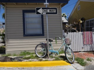 One of the old houses with a bike tied to a street sign in Key West, Florida.