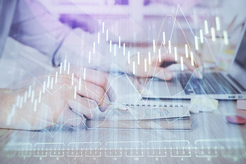 Multi exposure of financial graph with man works in office on background. Concept of analysis.