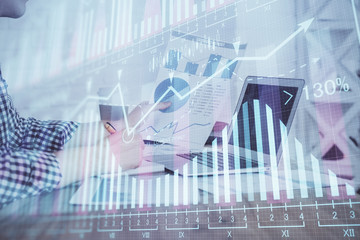 Multi exposure of financial graph with man works in office on background. Concept of analysis.