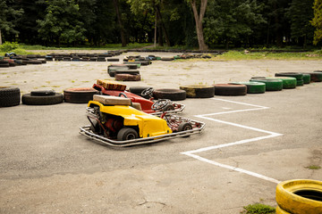 red and yellow kart bolides stay on start of track road fenced by tires 