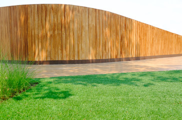 A wooden wall and green lawn