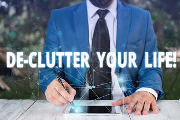 Handwriting text De Clutter Your Life. Conceptual photo remove unnecessary items from untidy or overcrowded places Male human wear formal work suit presenting presentation using smart device