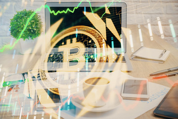 Double exposure of blockchain and crypto economy theme hologram and table with computer background....