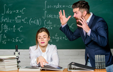 Man unhappy communicating. School principal talking about punishment. Conflict situation. School conflict. Demanding lecturer. Teacher strict serious bearded man having conflict with student girl - obrazy, fototapety, plakaty