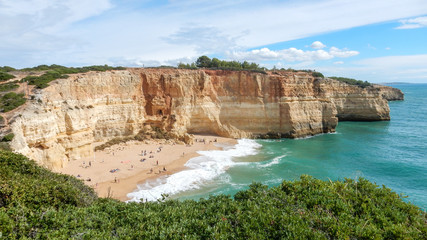 Fototapeta na wymiar Panoramic view of the ocean cliffs of the Algarve, Portugal, with cloudy blue sky
