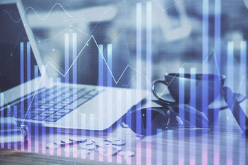 Obraz premium Financial chart drawing and table with computer on background. Double exposure. Concept of international markets.