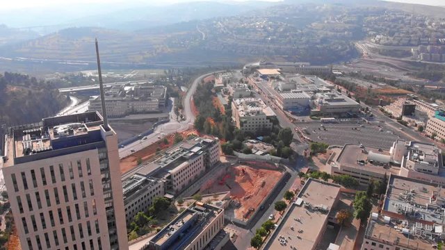 Top building with large antena , Jerusalem Mount Hotzvim Aerial Drone footage over Large building in Hi tech Park Jerusalem Israel