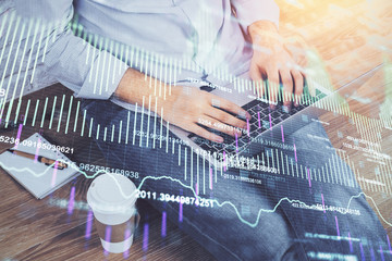 Double exposure of man's hands writing notes of stock market with forex graph background. Concept of research and trading.