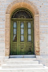 Fototapeta na wymiar old historic wooden door in Ermoupolis, Syros, Greece. Stock Image.