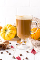 Traditional autumn dishes. Halloween, Thanksgiving. Mug of  hot and spicy aromatic pumpkin latte with whipped cream on top. Ingredients for cook spicy pumpkin latte on white background