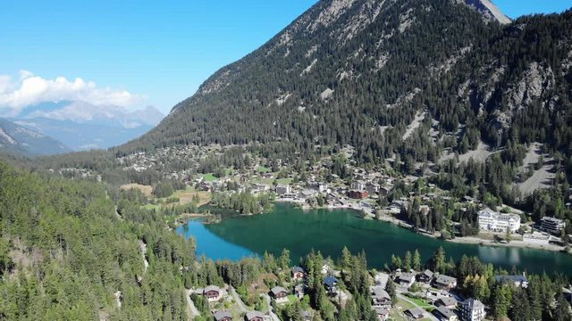 Champex-Lac iconic swiss village with beautiful lake aerial shot. Breathtaking panorama on a sunny morning