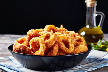 crispy calamari rings in a black bowl