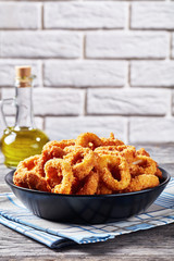 crispy calamari rings in a black bowl