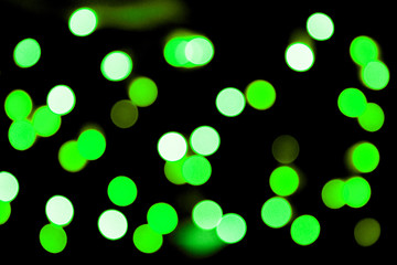 Unfocused abstract colourful bokeh black background. defocused and blurred many round green light