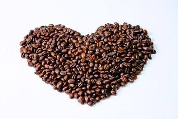Roasted coffee beans arranged in heart shape isolate on white background.
