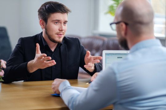 Confident young man attending job interview