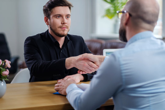 Confident young man attending job interview