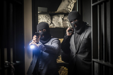 Two ardmed men robbing a bank