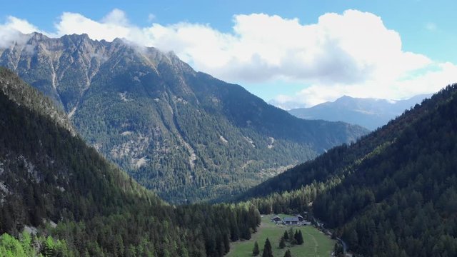 European alps iconic panorama aerial shot. Drone flying through the mountains on a bright summer day
