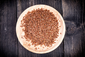 The Flax seeds in a wooden plate