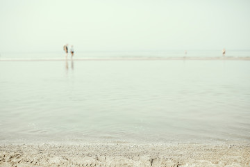 Fototapeta na wymiar People on the sandy beach shallow north sea summer vacation
