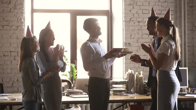 Employee receiving from colleagues birthday congrats during workday
