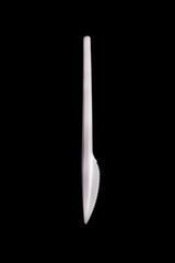 Plastic knife on a black background