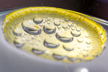 a slice of lemon with bubbles.  Fresh lemon slice in water with bubbles