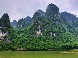 Beautiful mountain views overgrown with trees in Lijiang River, Yangshuo