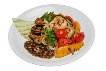 Grilled vegetables on a plate on a white isolated background