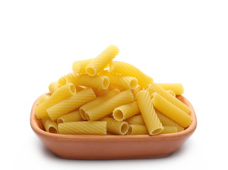 Pasta tubes, tortiglioni or elicoidali in clay pot, bowl isolated on white background
