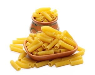Pasta tubes, tortiglioni or elicoidali in clay pot, bowl isolated on white background