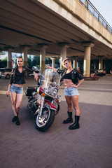 Fototapeta na wymiar Sexy gorgeous young women outdoors with motorcycle on road. Friendship, beauty, sexy lady, transportation concept
