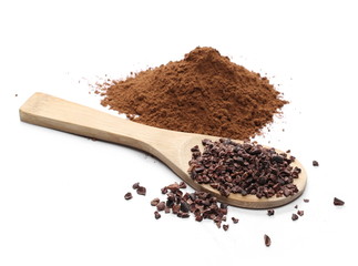 Chopped and powder cocoa pile with wooden spoon isolated on white background