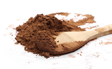 Cocoa powder pile with wooden spoon isolated on white background