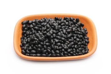 Black beans in clay bowl, pot isolated on white background