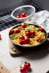 spaghetti with cherry tomatoes in a pan