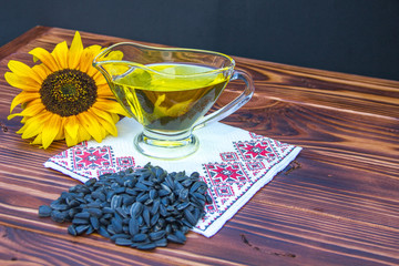 Obraz na płótnie Canvas wooden background with sunflower oil, seeds and a sunflower
