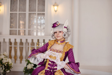 Fototapeta na wymiar Girl in barocco baroque rococo old vintage dress and wig, cosplay costume of 15 16 17 18 19 centur, make heart with hands