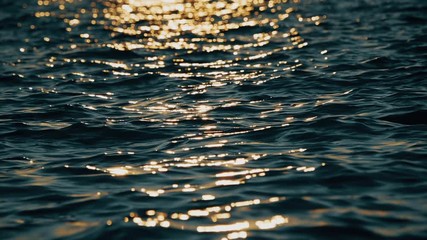 View of a deep blue sea rippling water surface reflecting the sunlight.