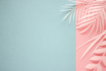 Tropical palm leaf on blue background. Flat lay, top view