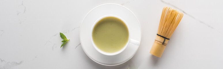 flat lay with cup of green matcha tea on white table